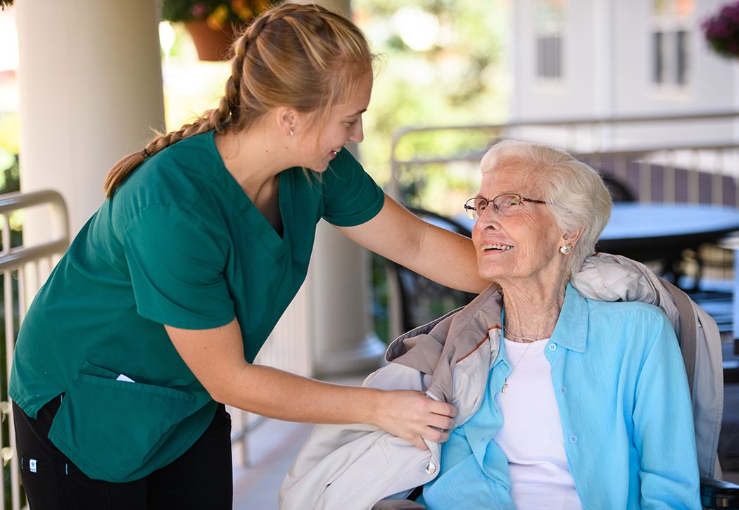 Nurse giving woman a jacket