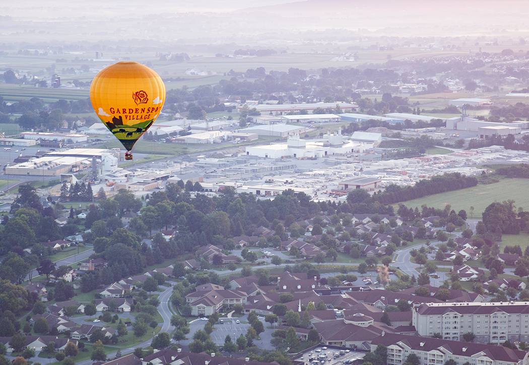 a hot air balloon with the words garden spa village on it
